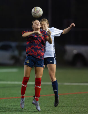 UDFC Senior women's soccer player challenges a Suburban FC First Team AAA opponent for a header during a Nova Scotia women's soccer match.